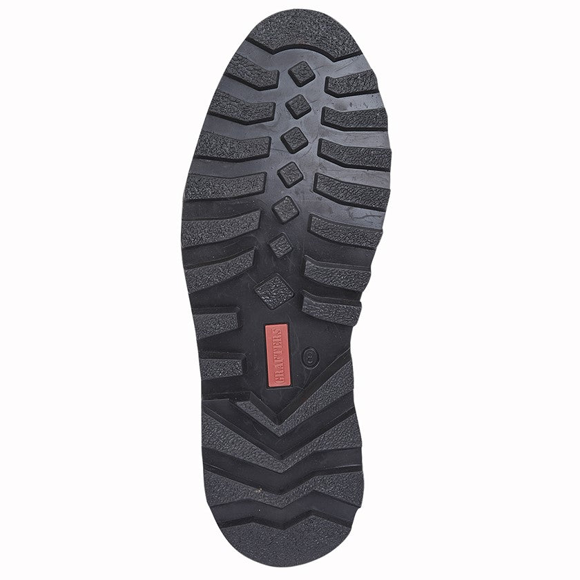 Close-up of a black shoe sole with a red label on a white background