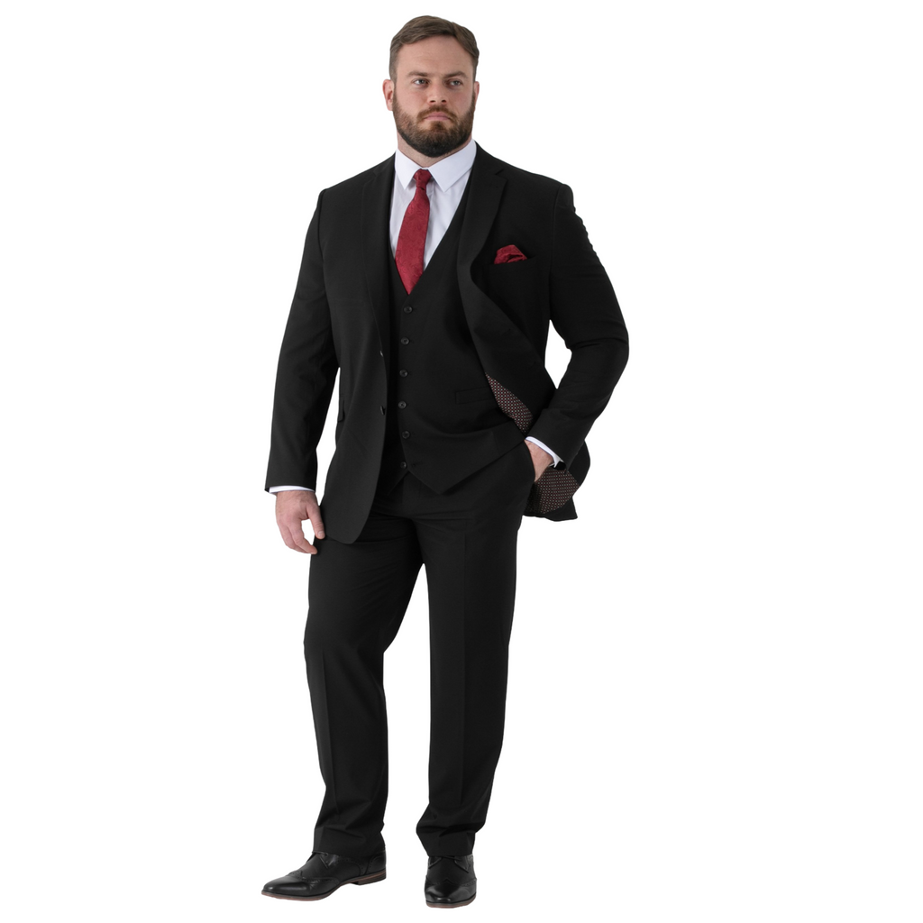 Man wearing a black suit with a red tie and pocket square on a white background