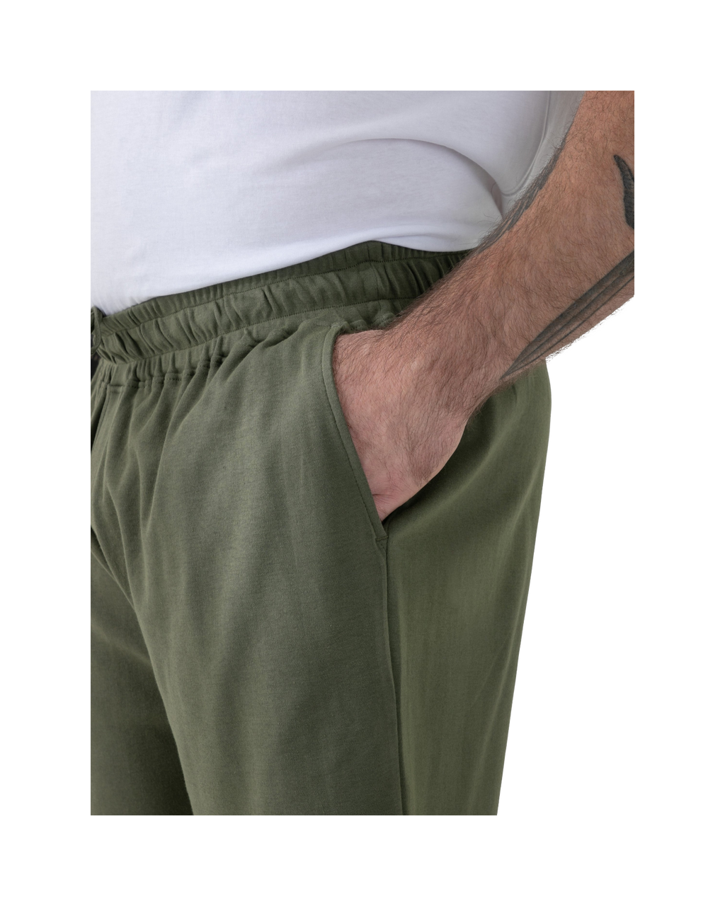 Person wearing olive green pants with a white shirt underneath.