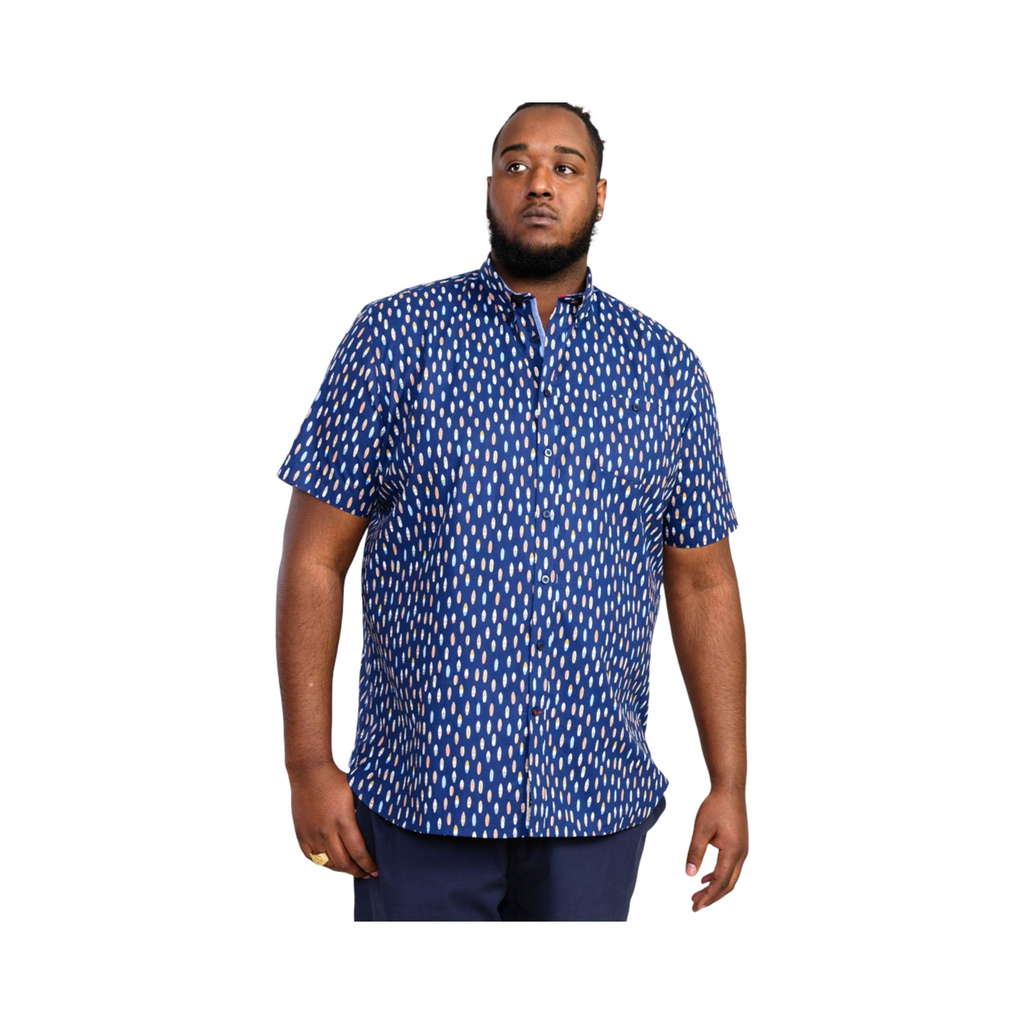 Man wearing a blue patterned shirt on a white background